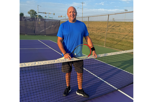 Jon Standing at a Tennis Net