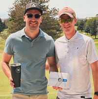 Customers holding For Wellness tumbler and golf balls