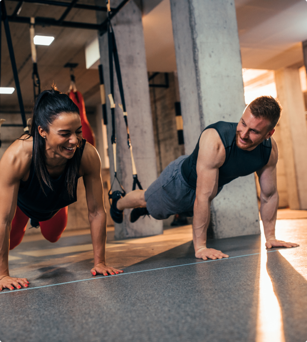 Photo of man and woman doing push ups