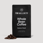 For Wellness Whole Bean Coffee Medium Roast bag with scattered coffee beans