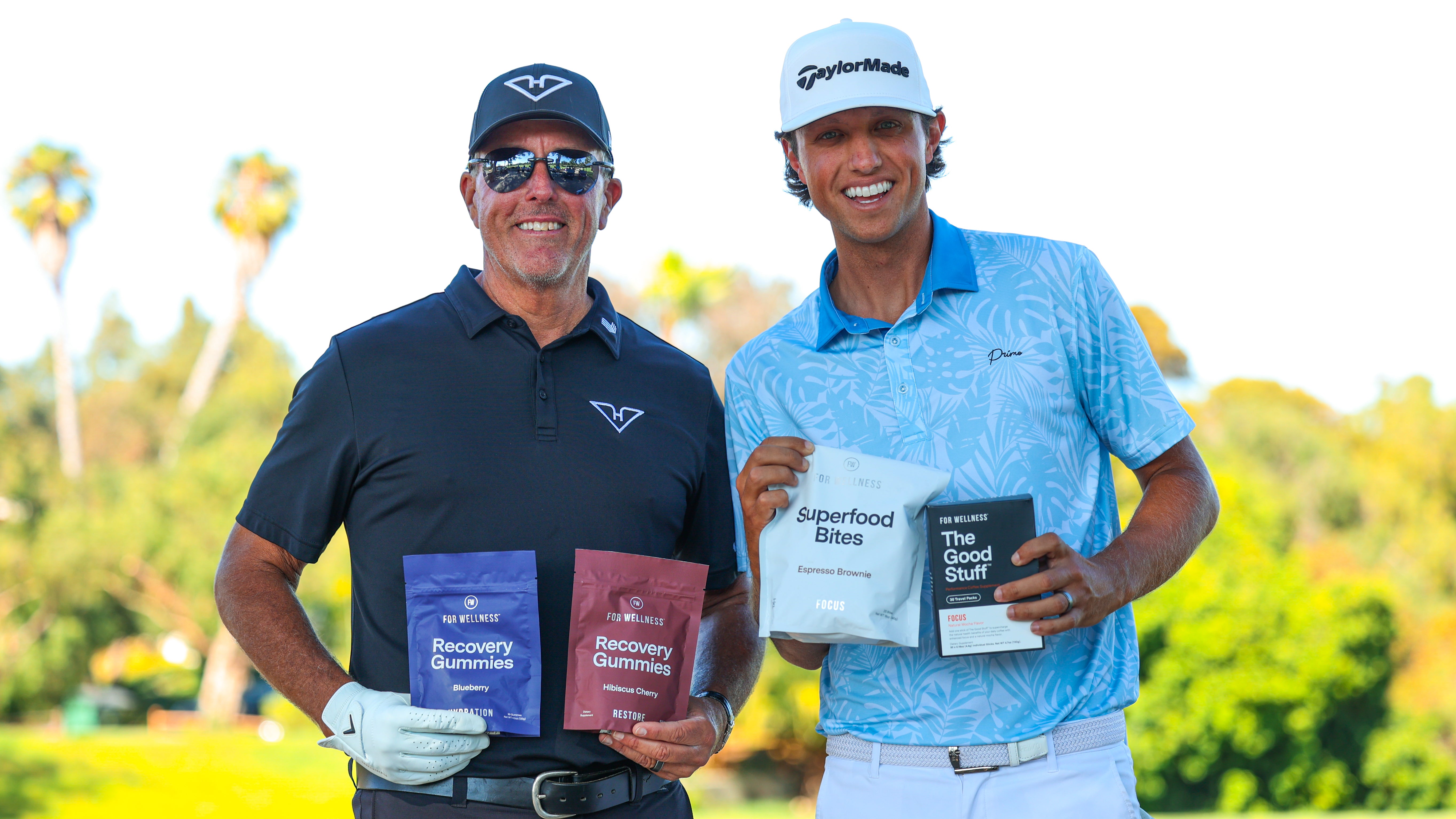 Phil Mickelson and Grant Horvat holding For Wellness products.