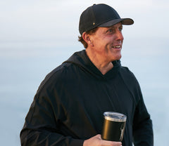 Photo of Phil Mickelson holding coffee tumbler